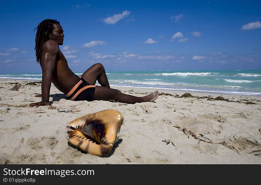 Man sitting on the beach in cuba