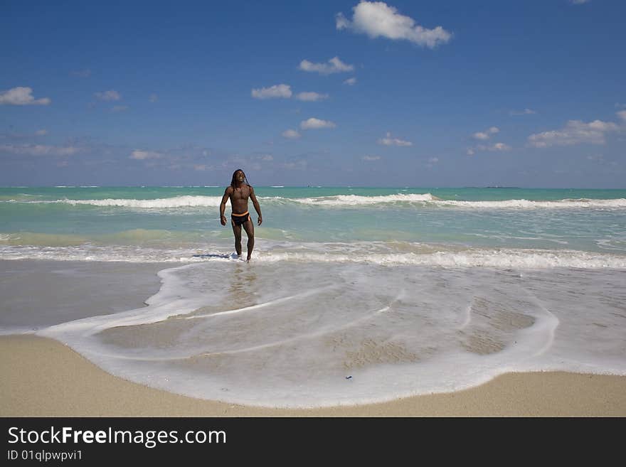 Black man going out the blue sea over blue sky. Black man going out the blue sea over blue sky