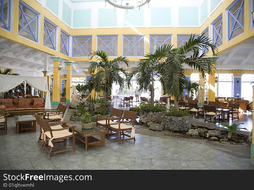 Yellow hotel in cuba with palm trees