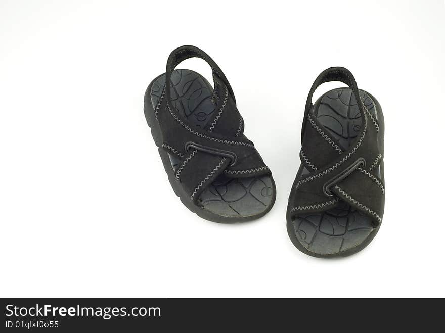 A pair of infant black summer sandals for a boy isolated on white background, horizontal with copy space. A pair of infant black summer sandals for a boy isolated on white background, horizontal with copy space