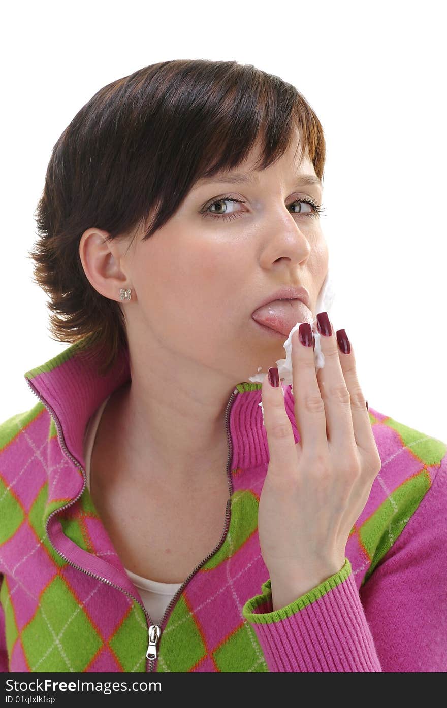 Young woman licking shaving foam on her palm isolated on white