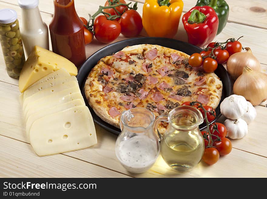 A couple of delicious pizzas, with raw tomatoes, green peppers and mushrooms. A couple of delicious pizzas, with raw tomatoes, green peppers and mushrooms