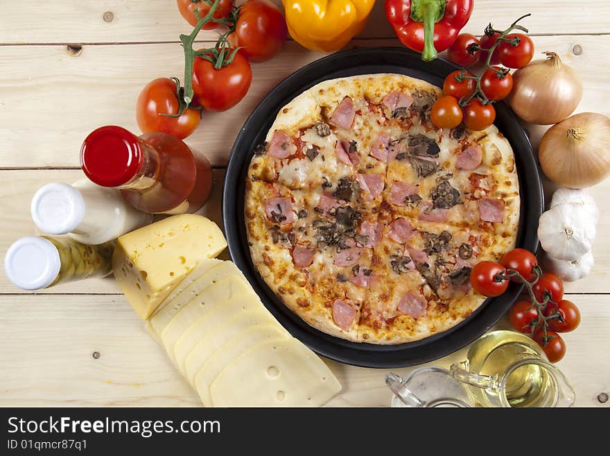 A couple of delicious pizzas, with raw tomatoes, green peppers and mushrooms. A couple of delicious pizzas, with raw tomatoes, green peppers and mushrooms