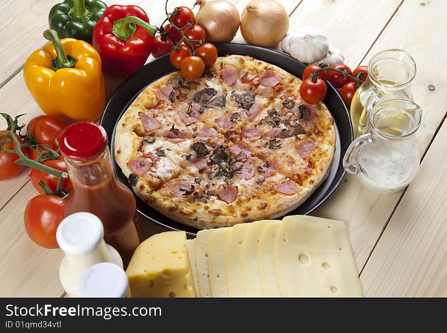 A couple of delicious pizzas, with raw tomatoes, green peppers and mushrooms. A couple of delicious pizzas, with raw tomatoes, green peppers and mushrooms