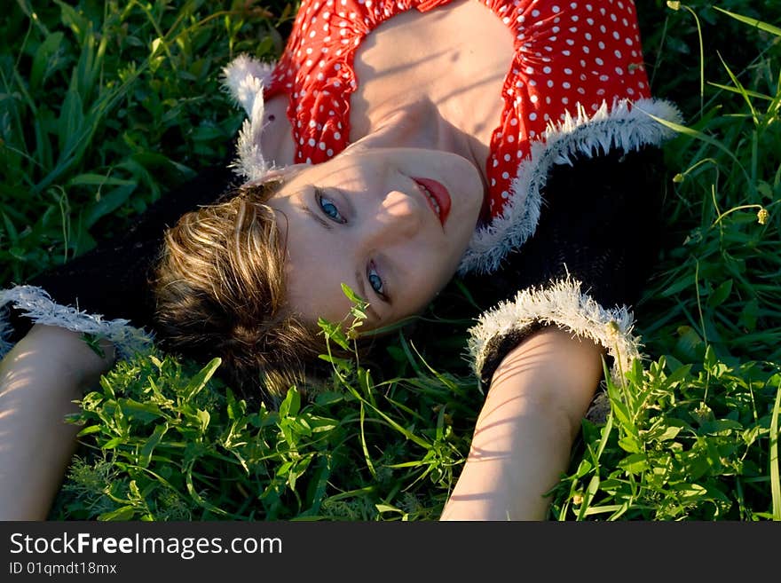 Portrait woman has a rest on grass