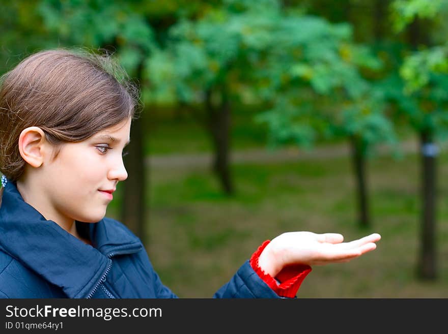 Portrait teen girl relax on big stone in park. Portrait teen girl relax on big stone in park