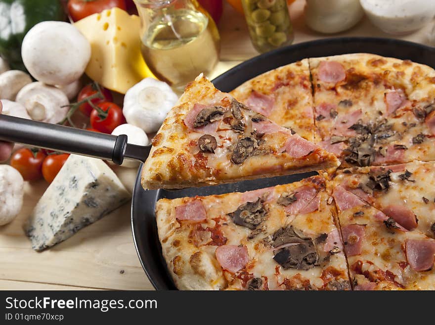 A couple of delicious pizzas, with raw tomatoes, green peppers and mushrooms. A couple of delicious pizzas, with raw tomatoes, green peppers and mushrooms