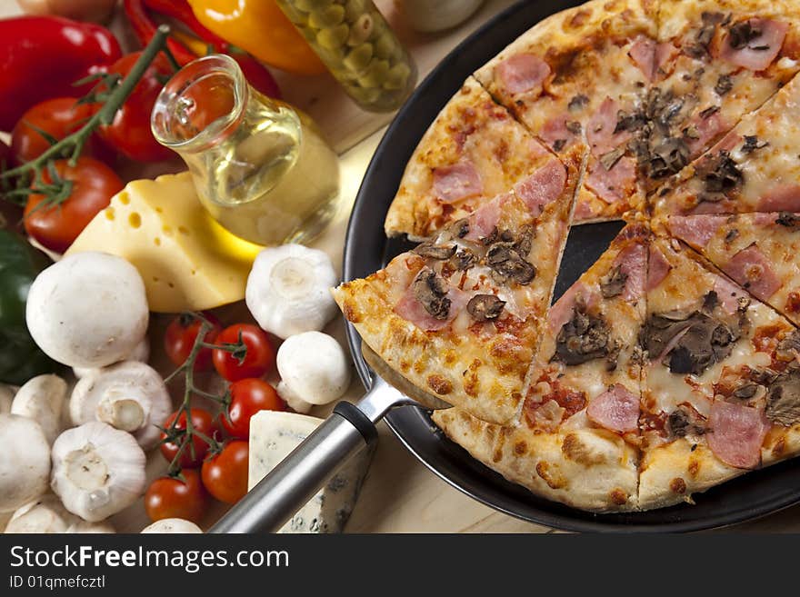 A couple of delicious pizzas, with raw tomatoes, green peppers and mushrooms. A couple of delicious pizzas, with raw tomatoes, green peppers and mushrooms