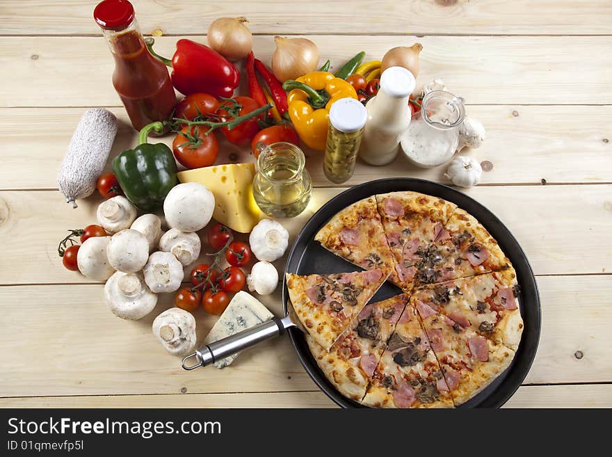 A couple of delicious pizzas, with raw tomatoes, green peppers and mushrooms. A couple of delicious pizzas, with raw tomatoes, green peppers and mushrooms