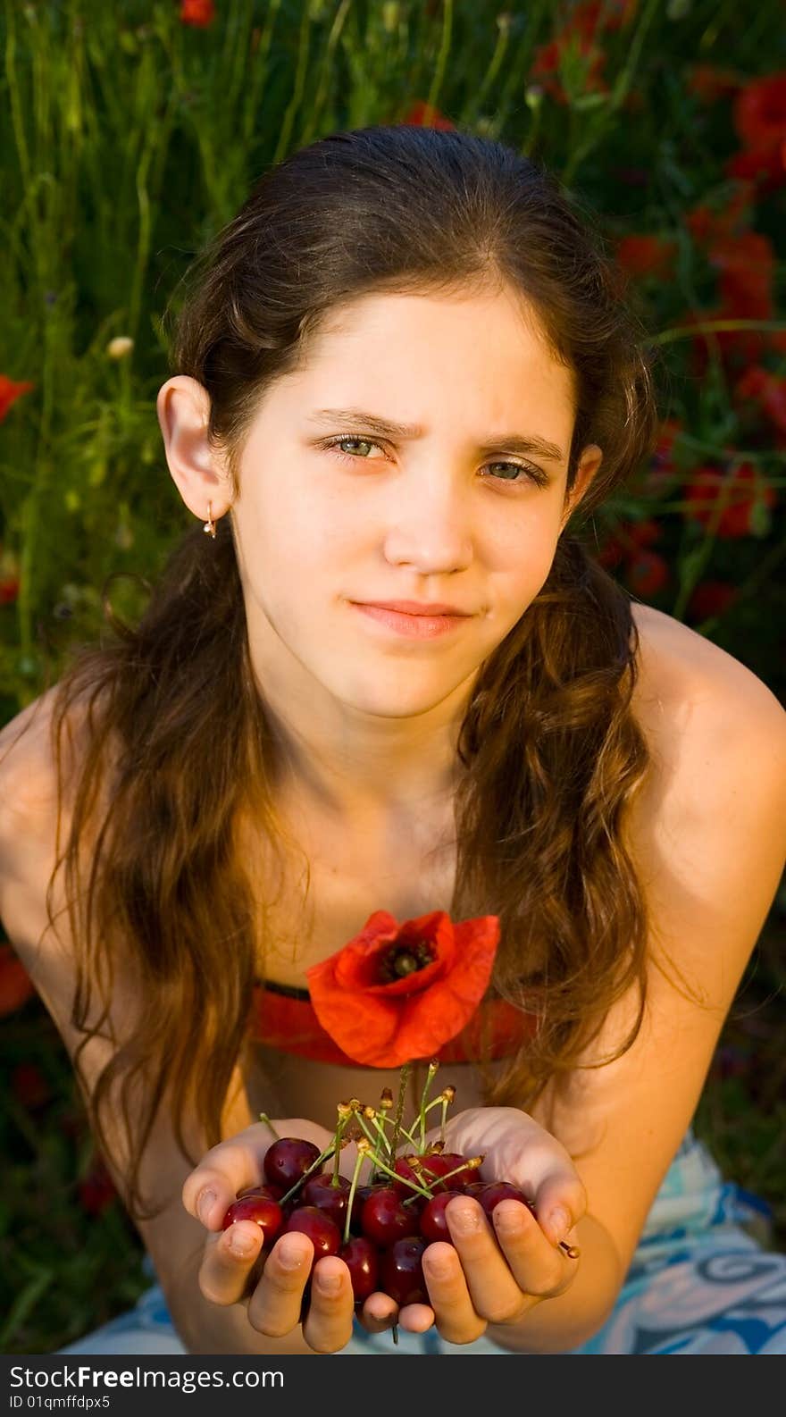 Portrait teen girl with poppy on nature