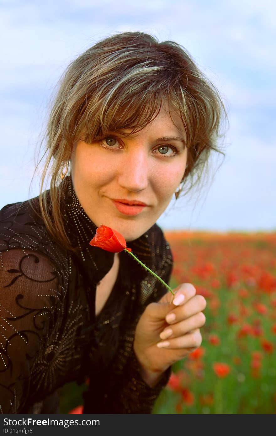 Portrait woman with poppy on nature