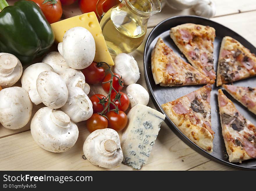 A couple of delicious pizzas, with raw tomatoes, green peppers and mushrooms. A couple of delicious pizzas, with raw tomatoes, green peppers and mushrooms