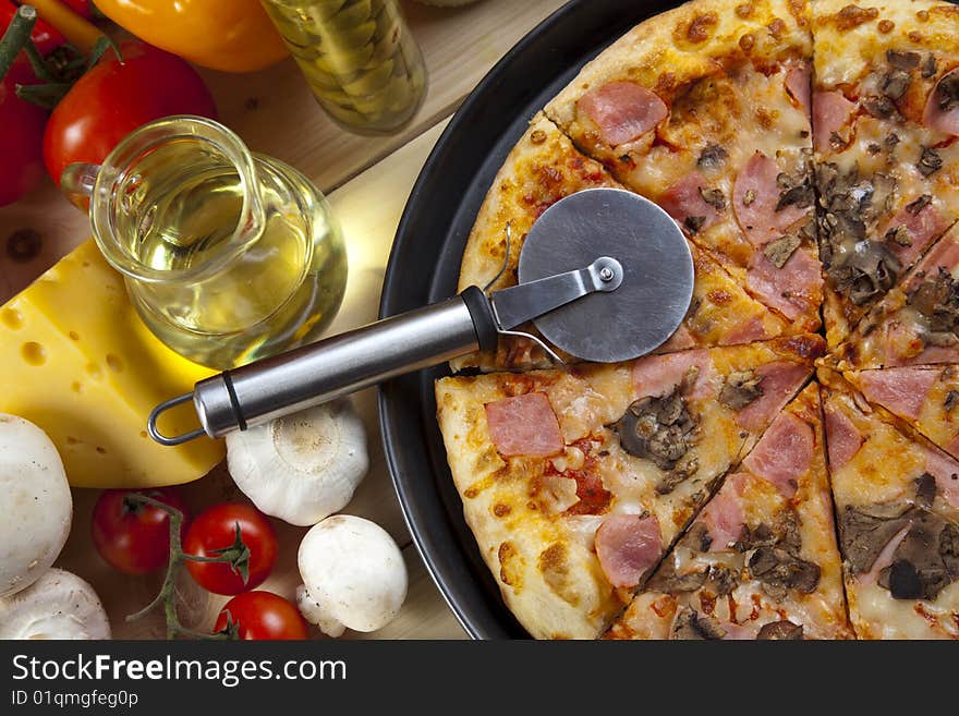 A couple of delicious pizzas, with raw tomatoes, green peppers and mushrooms. A couple of delicious pizzas, with raw tomatoes, green peppers and mushrooms