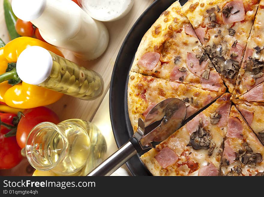 A couple of delicious pizzas, with raw tomatoes, green peppers and mushrooms. A couple of delicious pizzas, with raw tomatoes, green peppers and mushrooms