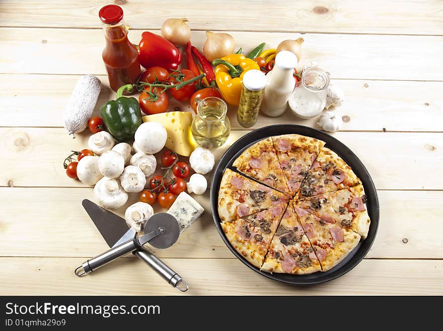 A couple of delicious pizzas, with raw tomatoes, green peppers and mushrooms. A couple of delicious pizzas, with raw tomatoes, green peppers and mushrooms