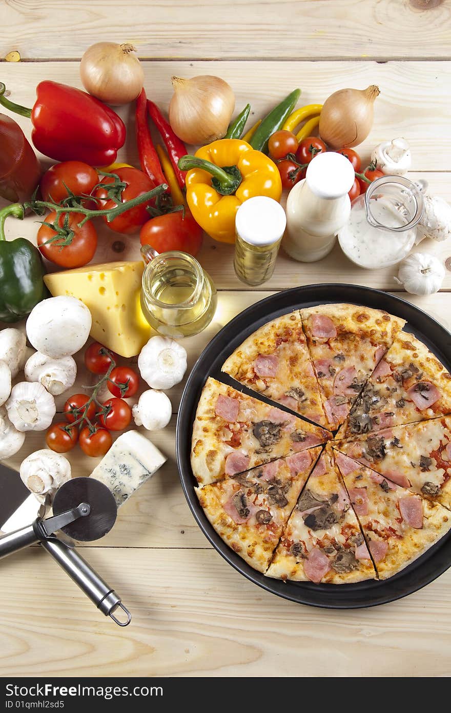 A couple of delicious pizzas, with raw tomatoes, green peppers and mushrooms. A couple of delicious pizzas, with raw tomatoes, green peppers and mushrooms