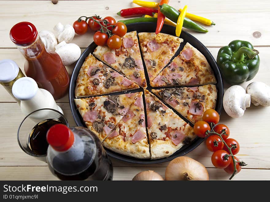 A couple of delicious pizzas, with raw tomatoes, green peppers and mushrooms. A couple of delicious pizzas, with raw tomatoes, green peppers and mushrooms