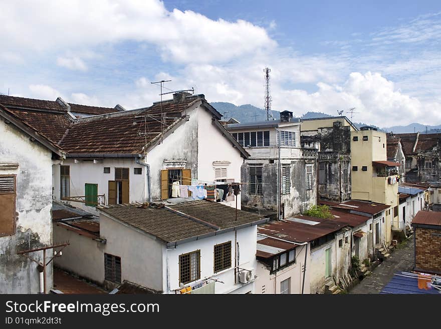 A row of old ruined houses against blue sky. A row of old ruined houses against blue sky