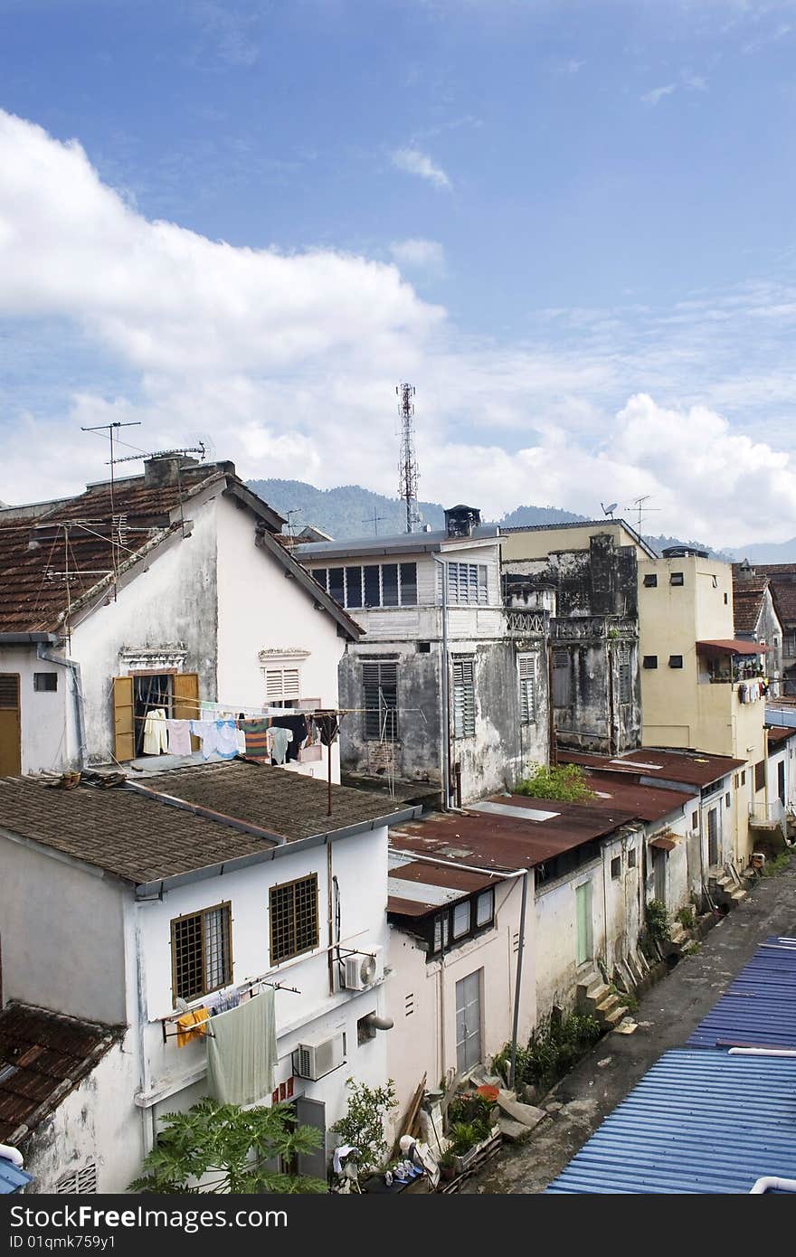 A row of old ruined houses against blue sky. A row of old ruined houses against blue sky