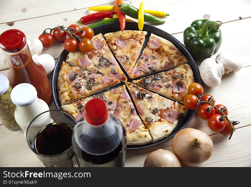 A couple of delicious pizzas, with raw tomatoes, green peppers and mushrooms. A couple of delicious pizzas, with raw tomatoes, green peppers and mushrooms