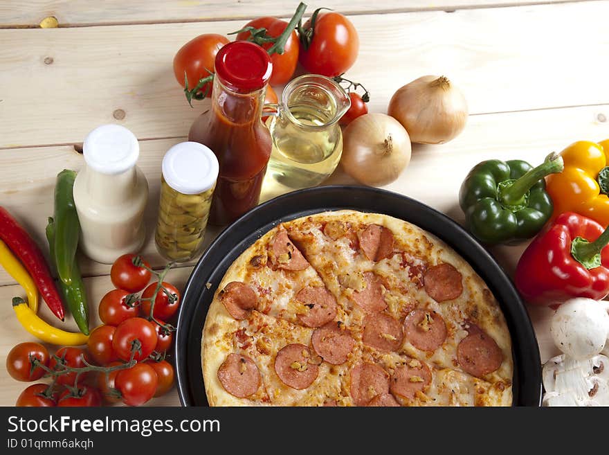 A couple of delicious pizzas, with raw tomatoes, green peppers and salami. A couple of delicious pizzas, with raw tomatoes, green peppers and salami