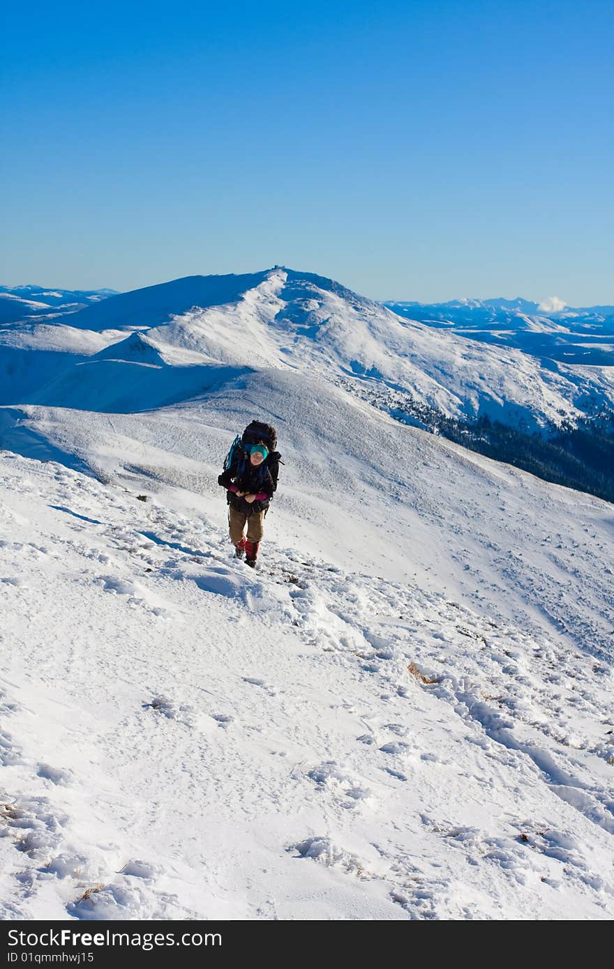 Hiker in high winter mountains