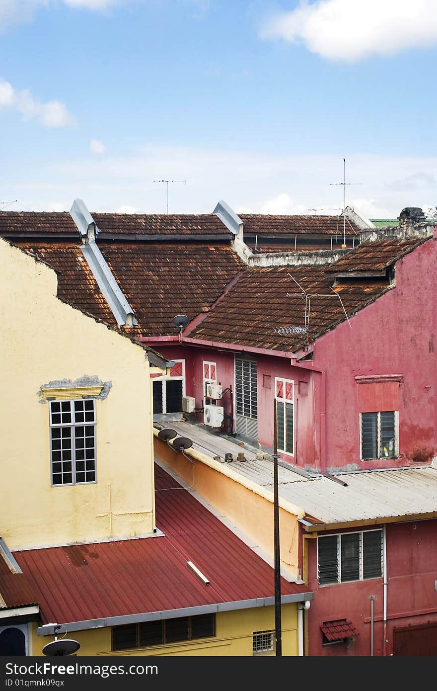 A row of old colorful houses against blue sky