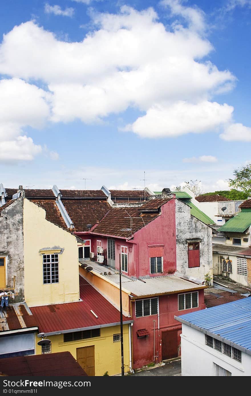 A row of old colorful houses against blue sky