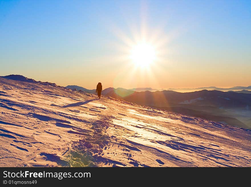 Hiker in high winter mountains