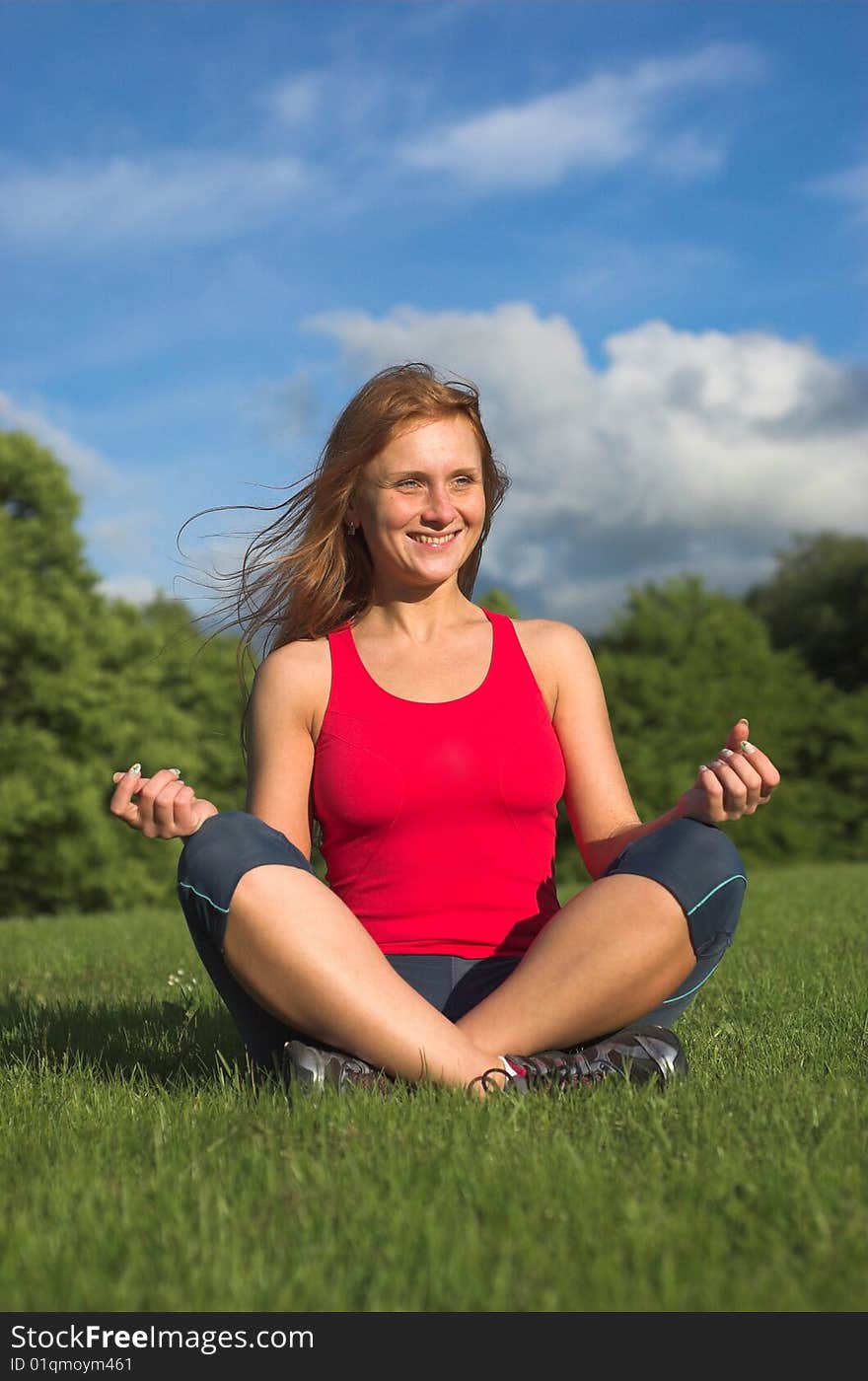 Young woman meditating in park. Young woman meditating in park