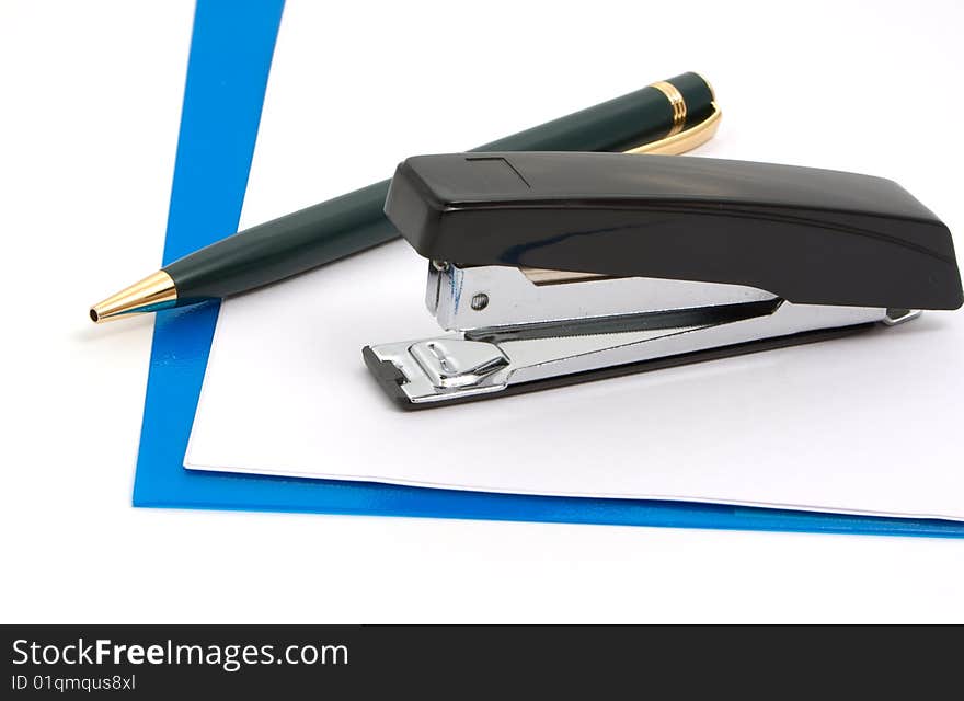 Business a still-life - black stapler, pen  and blue folder on white background. Business a still-life - black stapler, pen  and blue folder on white background