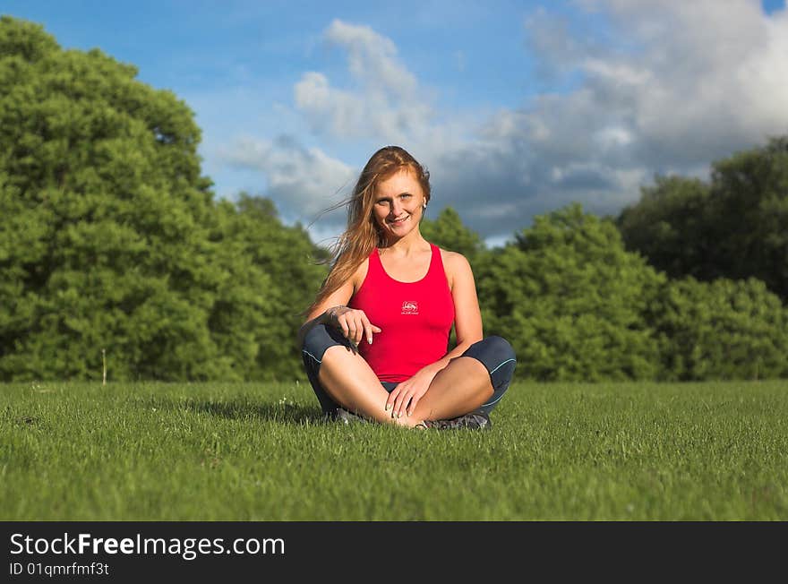 Young woman meditating in park. Young woman meditating in park