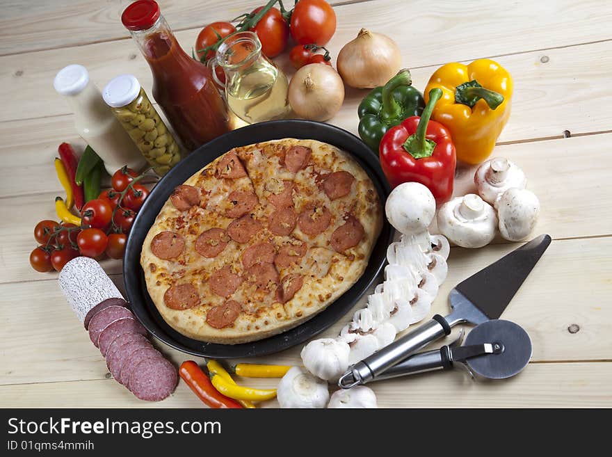 A couple of delicious pizzas, with raw tomatoes, green peppers and salami. A couple of delicious pizzas, with raw tomatoes, green peppers and salami