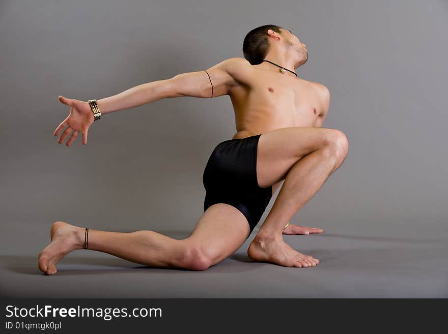 Young dancer over gray background