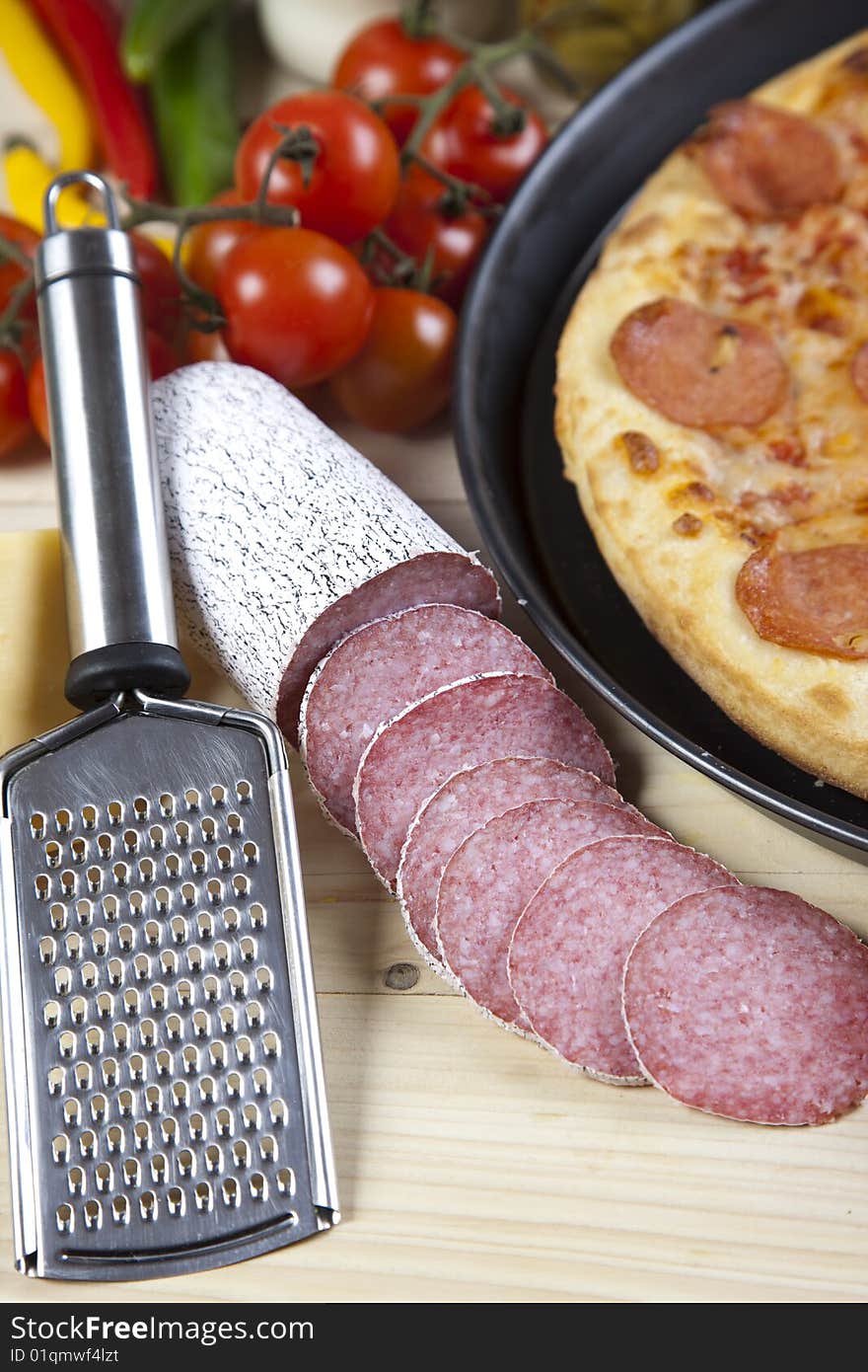 A couple of delicious pizzas, with raw tomatoes, green peppers and salami. A couple of delicious pizzas, with raw tomatoes, green peppers and salami