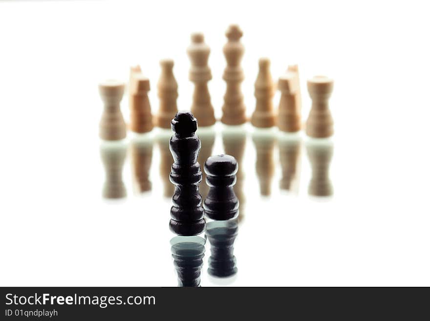 Black Chess King and single pawn against white chess army on white background. Black Chess King and single pawn against white chess army on white background