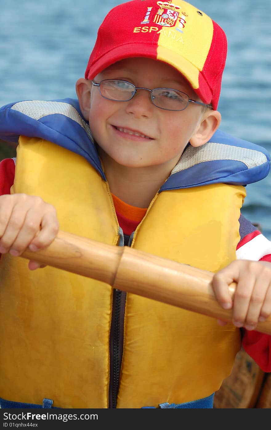 Young Boy holding the oar of a rowing boat. Young Boy holding the oar of a rowing boat