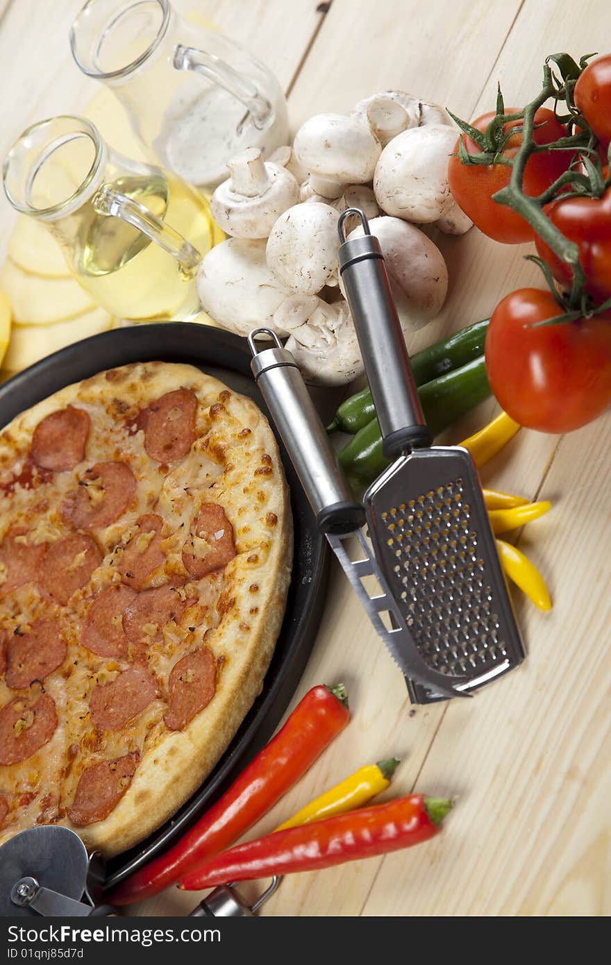 A couple of delicious pizzas, with raw tomatoes, green peppers and salami. A couple of delicious pizzas, with raw tomatoes, green peppers and salami