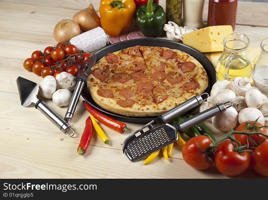 A couple of delicious pizzas, with raw tomatoes, green peppers and salami. A couple of delicious pizzas, with raw tomatoes, green peppers and salami