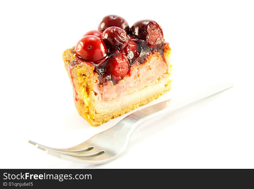 Slice of pork pie and a fork with clipping path on a white background. Slice of pork pie and a fork with clipping path on a white background