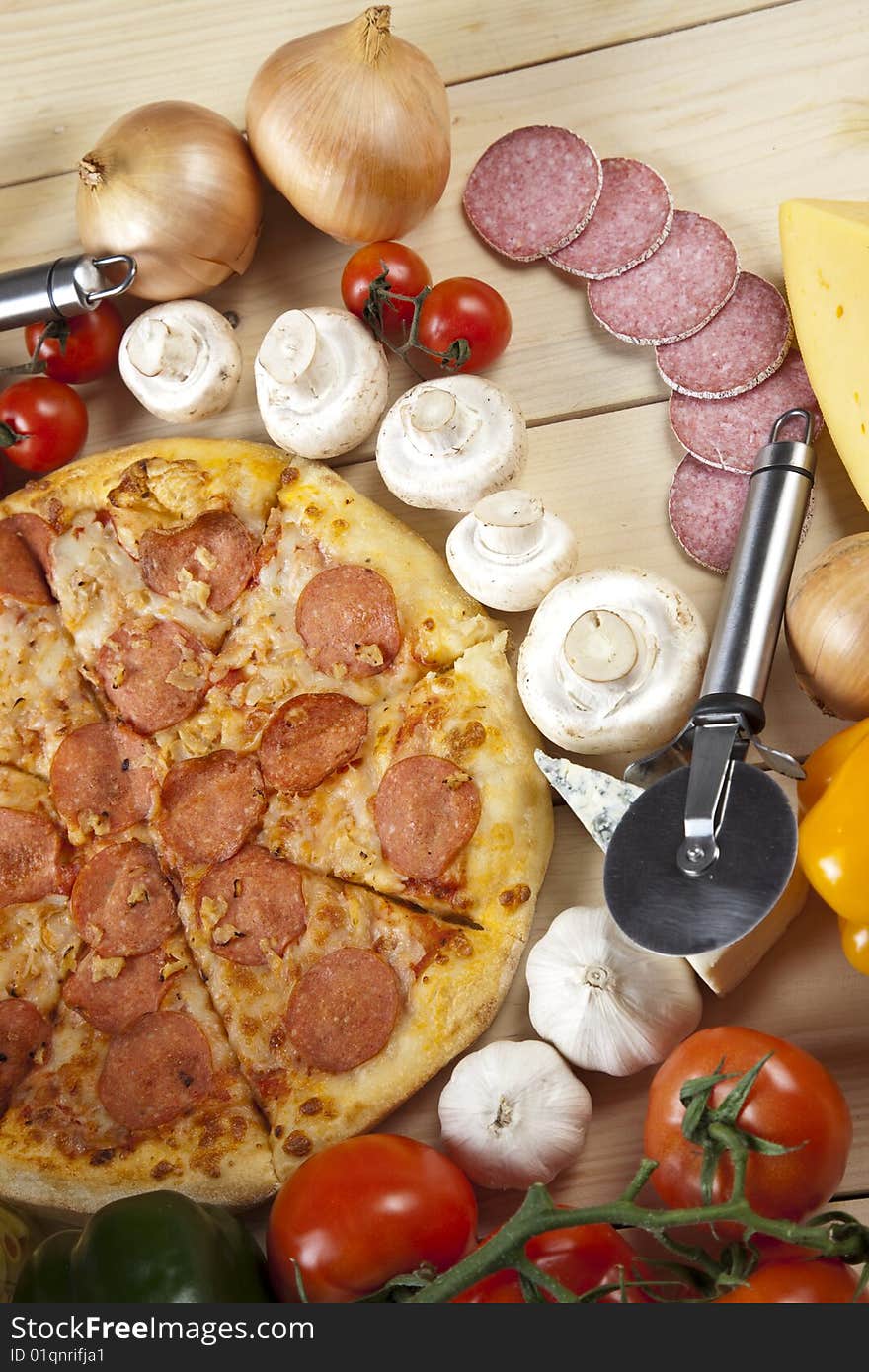 A couple of delicious pizzas, with raw tomatoes, green peppers and salami. A couple of delicious pizzas, with raw tomatoes, green peppers and salami