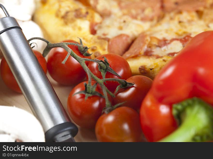 A couple of delicious pizzas, with raw tomatoes, green peppers and salami. A couple of delicious pizzas, with raw tomatoes, green peppers and salami