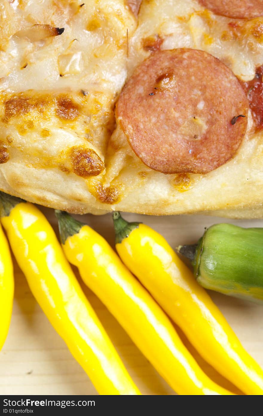 A couple of delicious pizzas, with raw tomatoes, green peppers and salami. A couple of delicious pizzas, with raw tomatoes, green peppers and salami