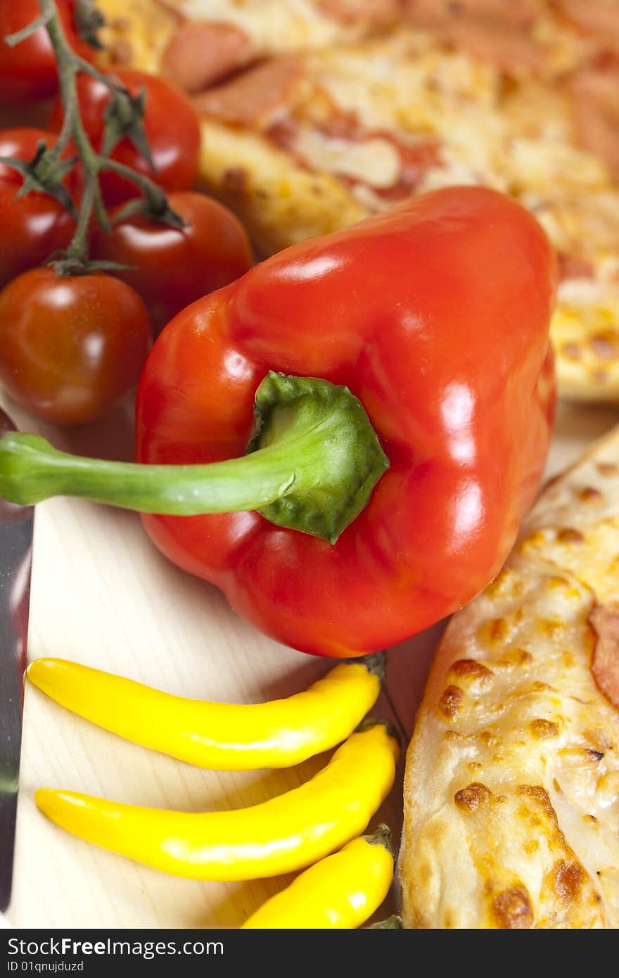 A couple of delicious pizzas, with raw tomatoes, green peppers and salami. A couple of delicious pizzas, with raw tomatoes, green peppers and salami