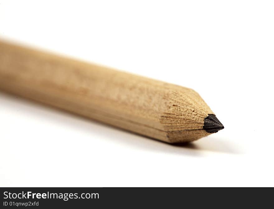 Wooden pencil close-up, isolated on a white background