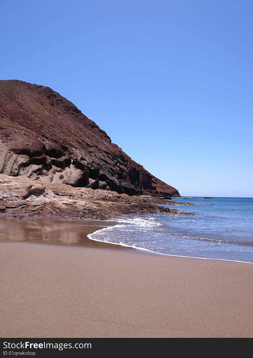 A secluded cove in a sub tropical island with the Atlantic Ocean dently lapping the shoreline. A secluded cove in a sub tropical island with the Atlantic Ocean dently lapping the shoreline