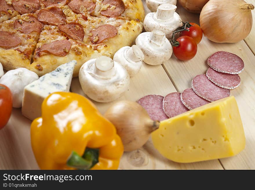 A couple of delicious pizzas, with raw tomatoes, green peppers and salami. A couple of delicious pizzas, with raw tomatoes, green peppers and salami