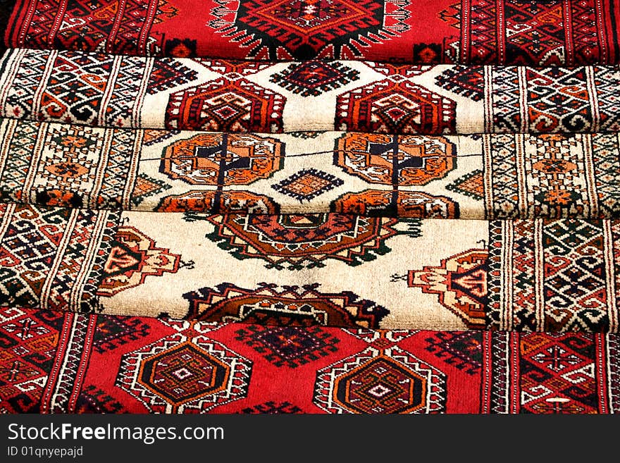 Few handmade carpets with traditional ornament. Turkmenistan. Ashkhabad market.