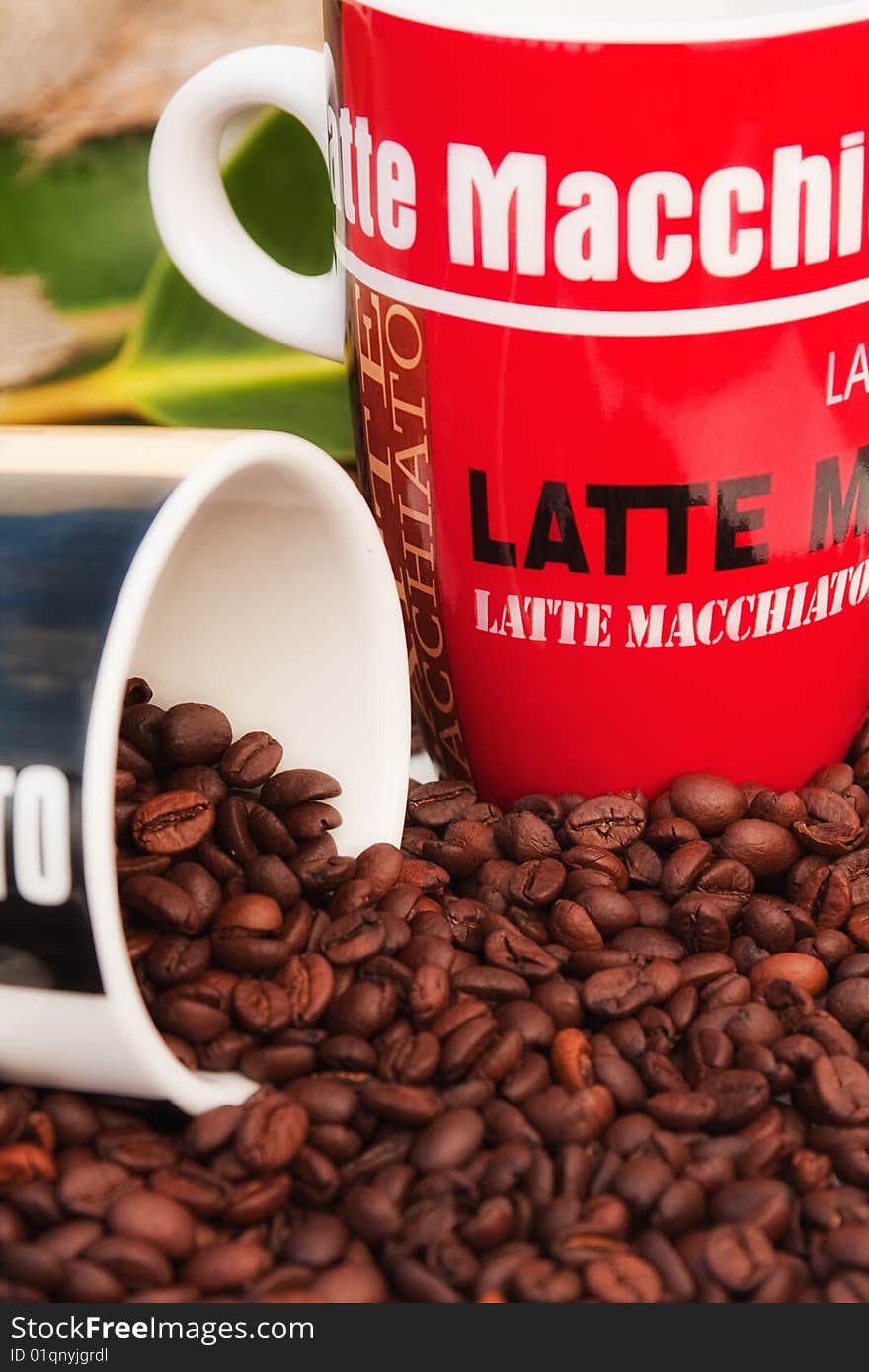 Coffee mug filled with Espresso coffee beans. Coffee mug filled with Espresso coffee beans.