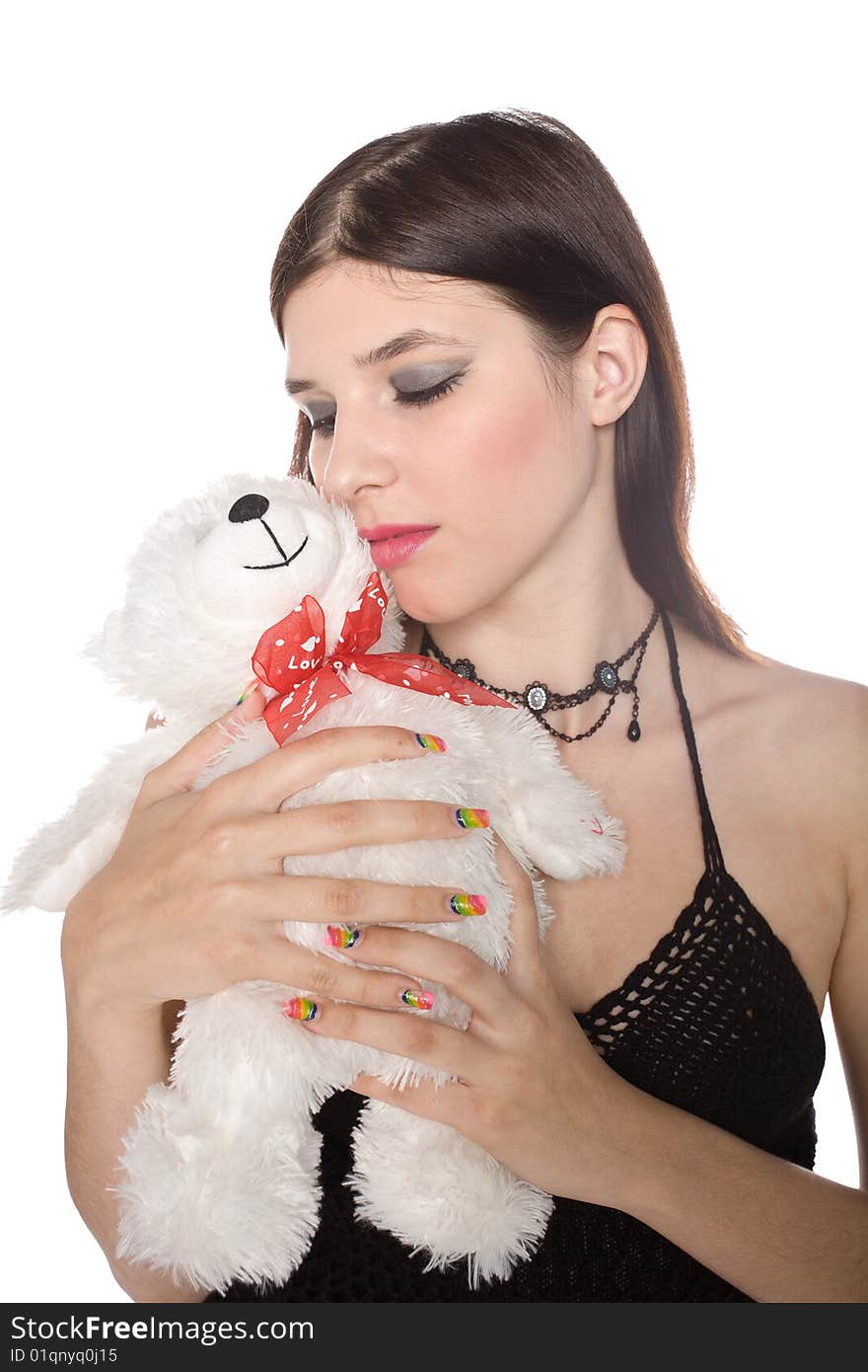 Girl with a teddy bear isolated on white